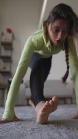 woman doing yoga stretches at home