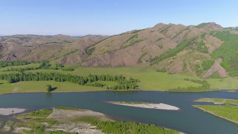 aerial view of a river winding through a green valley