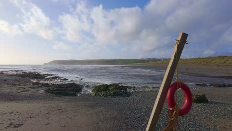 lifebouy ơn una playa en la costa del cobre waterford irlanda después de una tormenta de invierno en la playa de bunmahon en una mañana fría