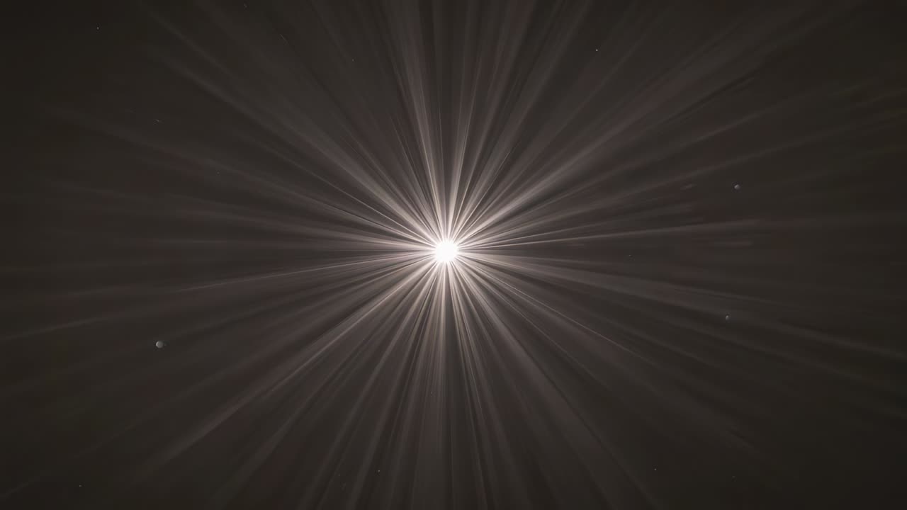 Frames advancing causing brightening central light emitting rays in dark void with halo left speck