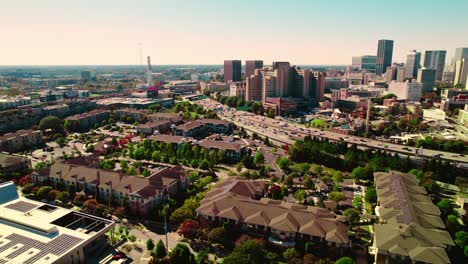 Aerial-of-Atlanta,-Georgia-the-houses,-highway-and-the-skyscrapers-in-the-background