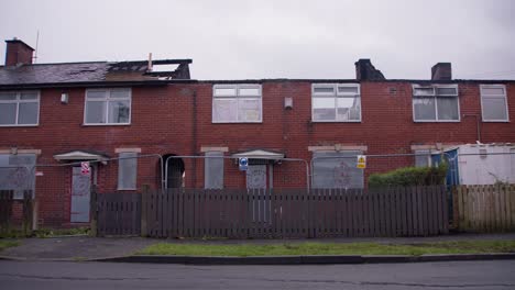 fire damaged home in blackburn, uk with roof collapsed