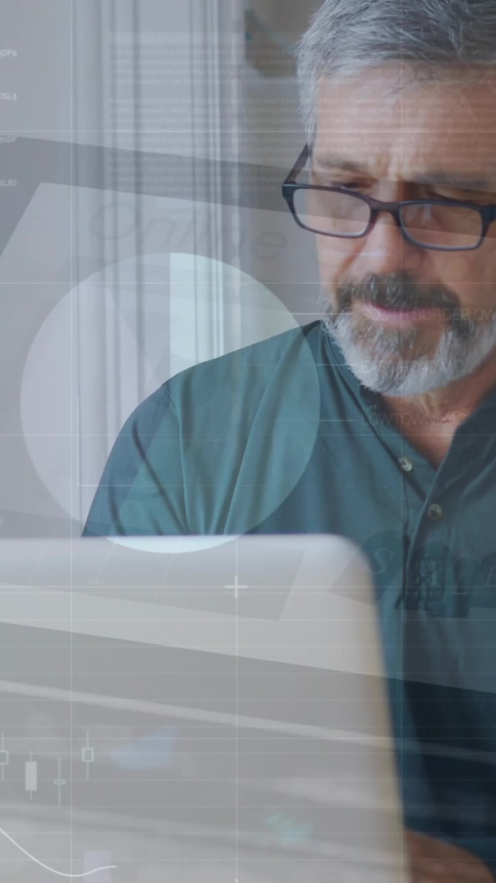 Animation of infographic interface over caucasian man wearing spectacles working on laptop