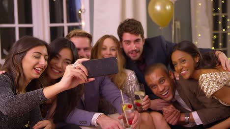 friends posing for photo as they celebrate at party together