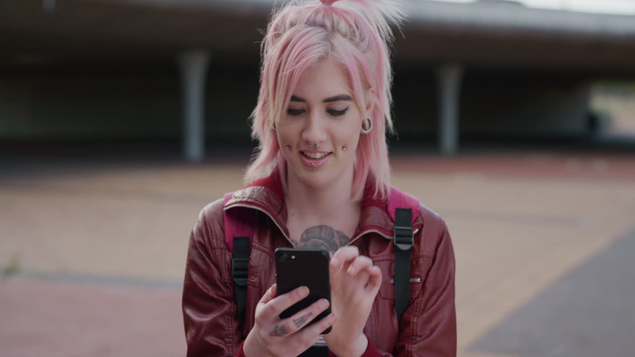 portrait young caucasian woman pink hair using smartphone texting enjoying browsing sms messages on mobile phone communication app real people series