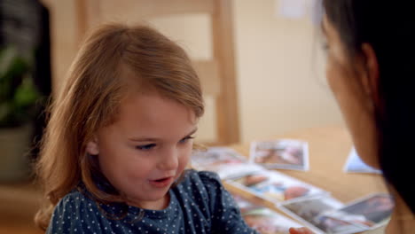 Mother-And-Daughter-Playing-Game-With-Hands-At-Home-Together