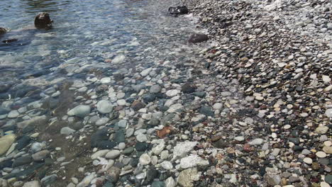 mediterranean sea lapping on pebbled rocky aphrodite beach cyprus