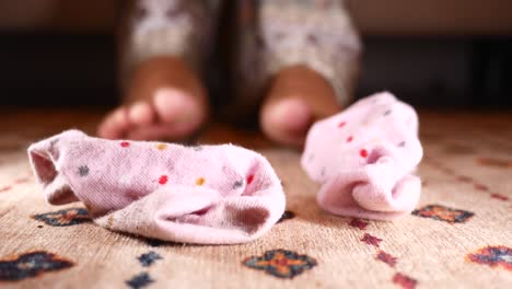 dirty pink socks on the floor