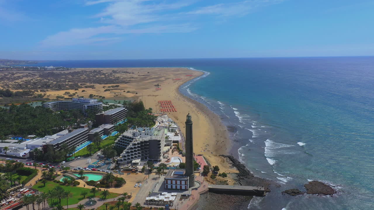 Aerial orbiting shot of the beautiful lighthouse revealing wide sand beach at the Texel island (part of Wadden islands) in The Netherlands