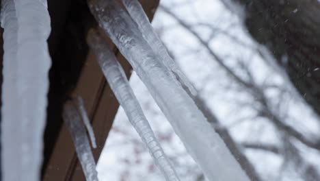 handheld shot of large icicles hanging off a balcony