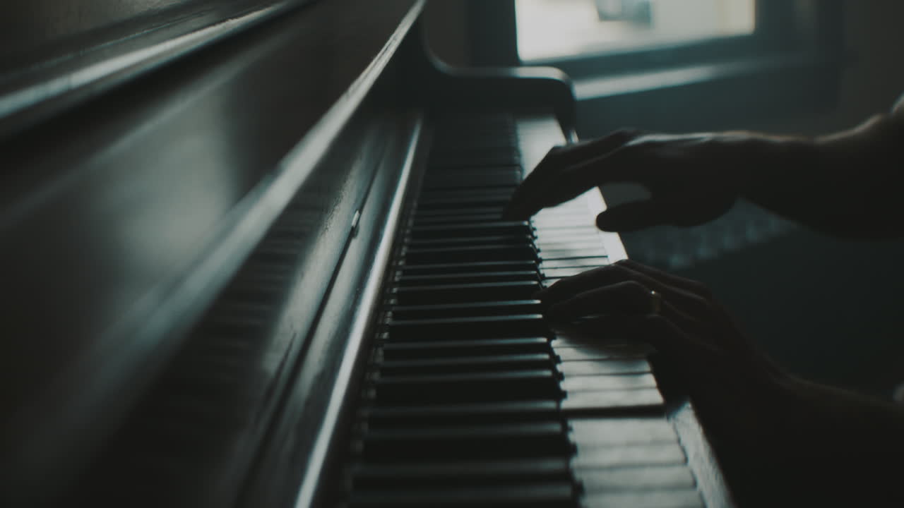 A man is playing piano indoors