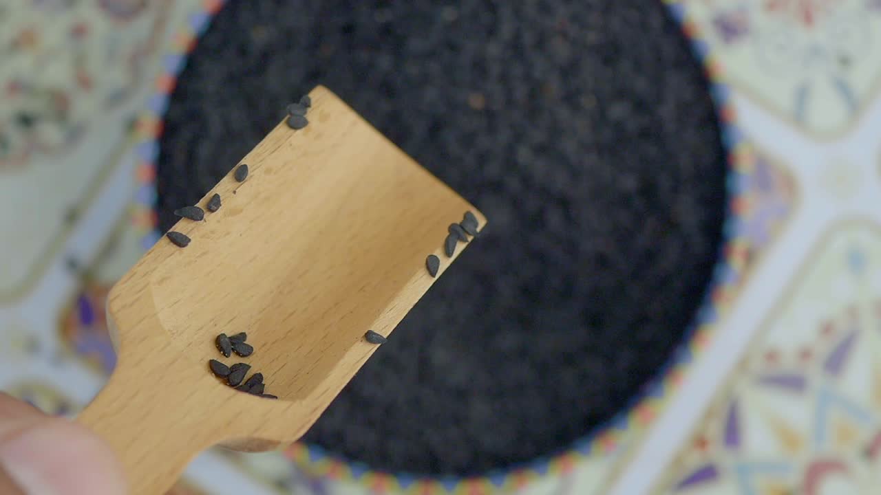 Black Nigella Seeds in Wooden Scoop