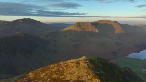 mountain landscape in autumn sunrise with high altitude flight towards misty mountain range