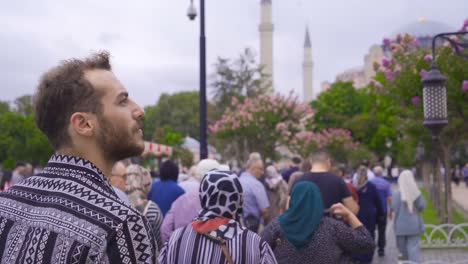 young man walking in the crowd.