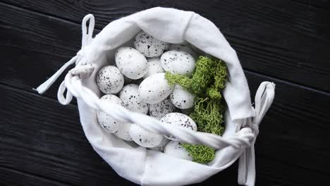 Quail-eggs-in-a-nest-on-a-black-rustic-wooden-background--Easter-symbols