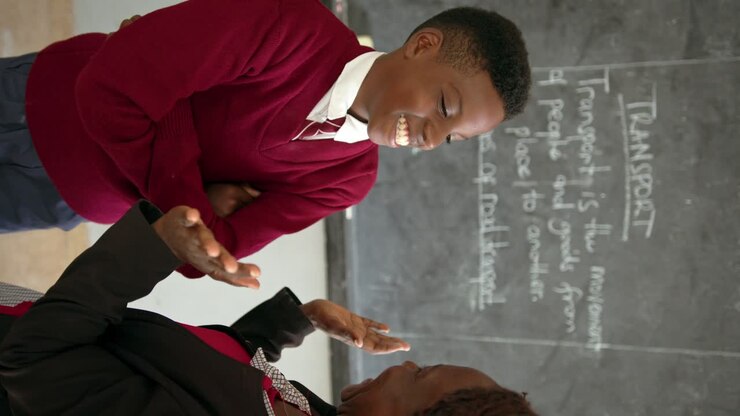 Happy Student Gets Praise By His Teacher - Vertical Shot