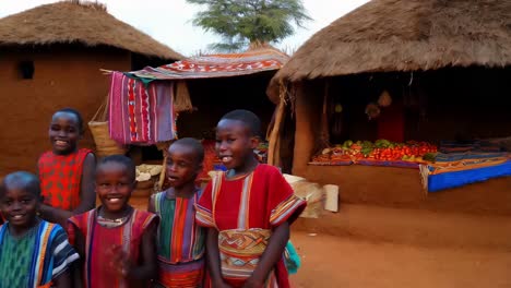 african children in traditional attire at a village market