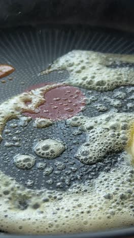 butter melting and sizzling in a hot pan