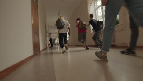 students running in school hallway