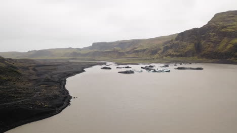 low aerial flight of waters and glaciers in iceland