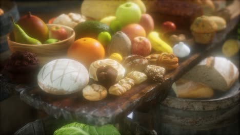 mesa de comida con barriles de vino y algunas frutas, verduras y pan