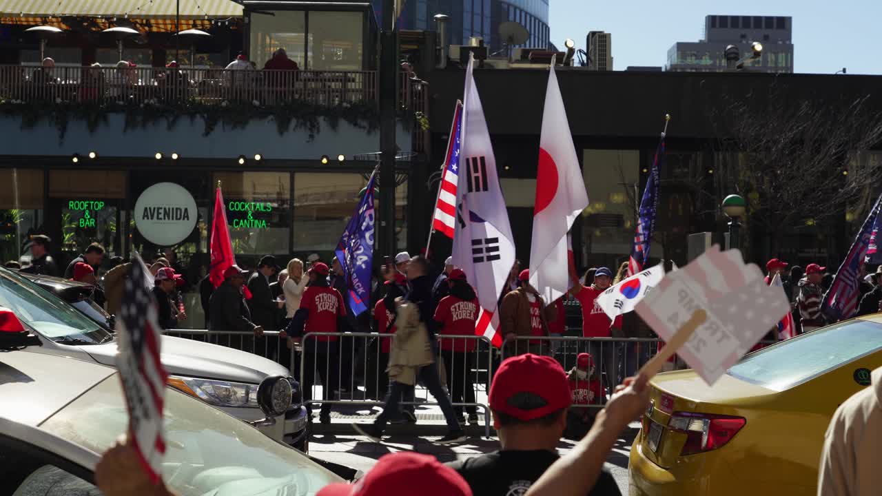 Crowds gather outside Madison Square Garden in New York, their energy palpable as they show their support for Trump under the bright afternoon sun