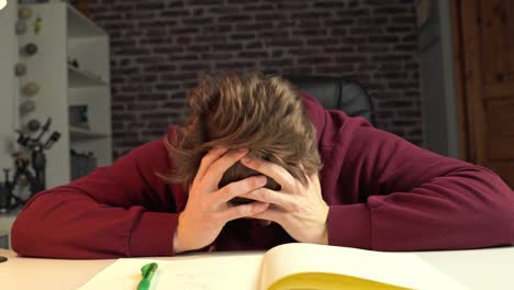 a student engineer is in deep thought and taking notes