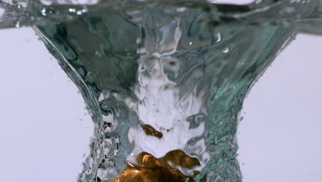 kiwi fruit falling into water