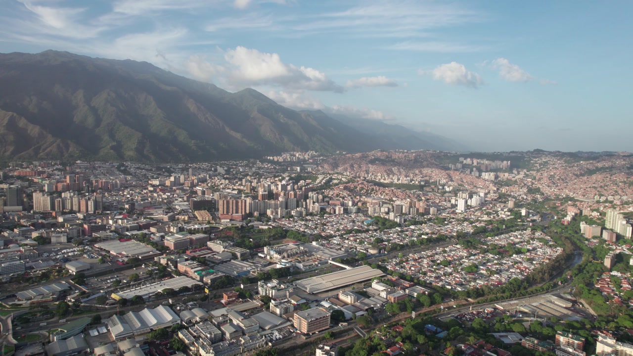 Aerial view of Los Ruices cityscape with mountains and blue sky