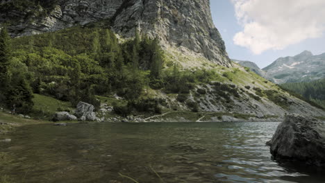 a camera shot of a lake in the valley surrounded by mountains