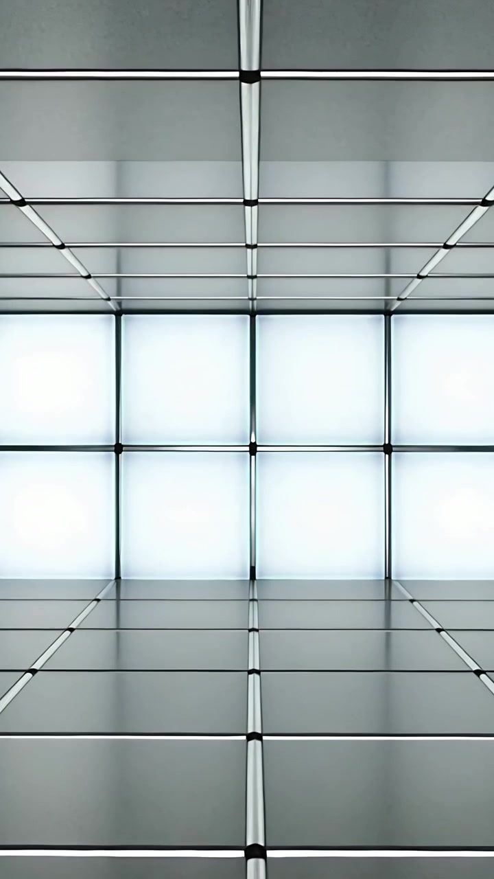 Vertical video: Pulling back camera revealing 3x3 light panels in gallery, exposing metal columns