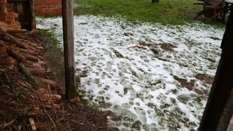 Water-drips-from-the-metal-roof-of-an-old-miner's-cottage-with-snow-on-the-ground