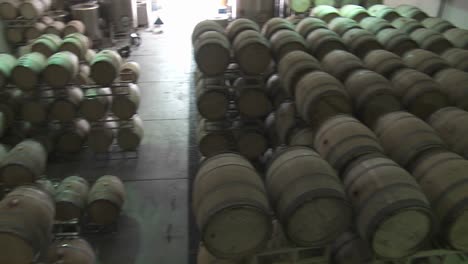 pan across barrels of beer in a warehouse