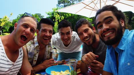 group of happy friends having fun together at outdoors barbecue party