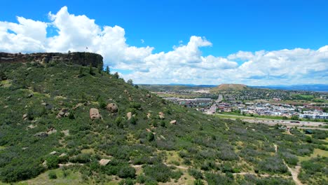 Revealing-aerial-shot-of-Castle-Rock-Colorado-City-with-Denver-and-mountains-in-the-background