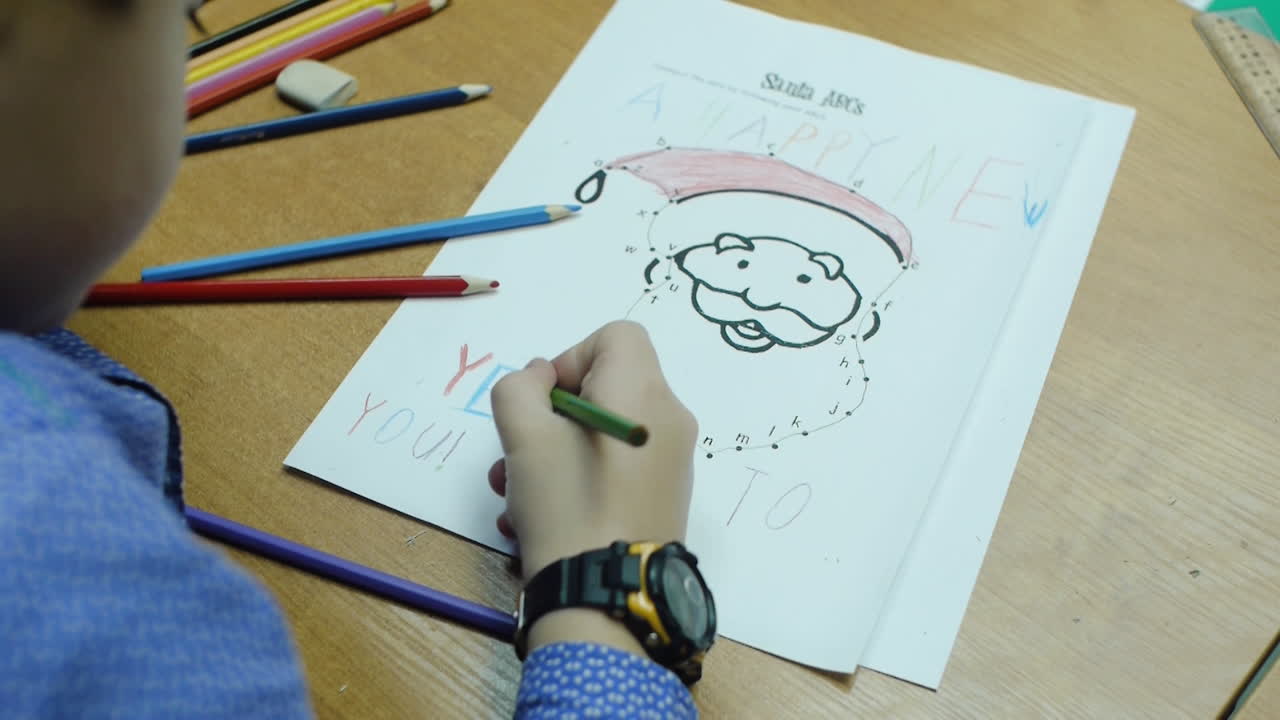 Child Coloring a Dot-to-Dot of Santa Claus