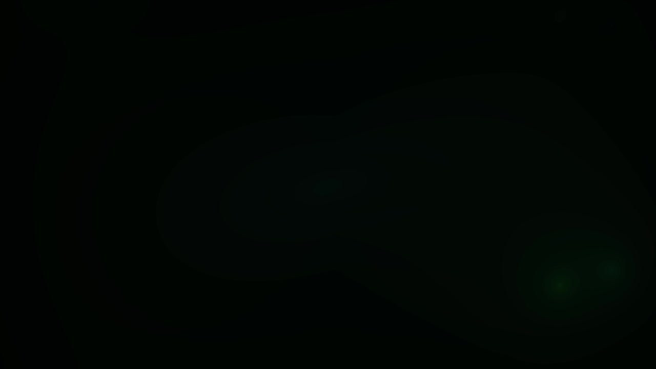 Subtle Green Lens Flare Overlay on Black Background