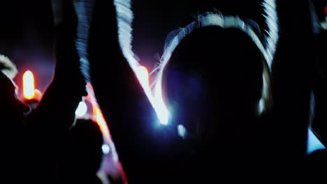 Fans-Are-Dancing-At-A-Rock-Concert-Visible-Silhouettes-Rear-View-4k-10-Bit-Video