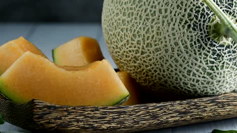 whole and sliced of japanese melons,honey melon or cantaloupe (cucumis melo) glass of melon smoothie healthcare concept.