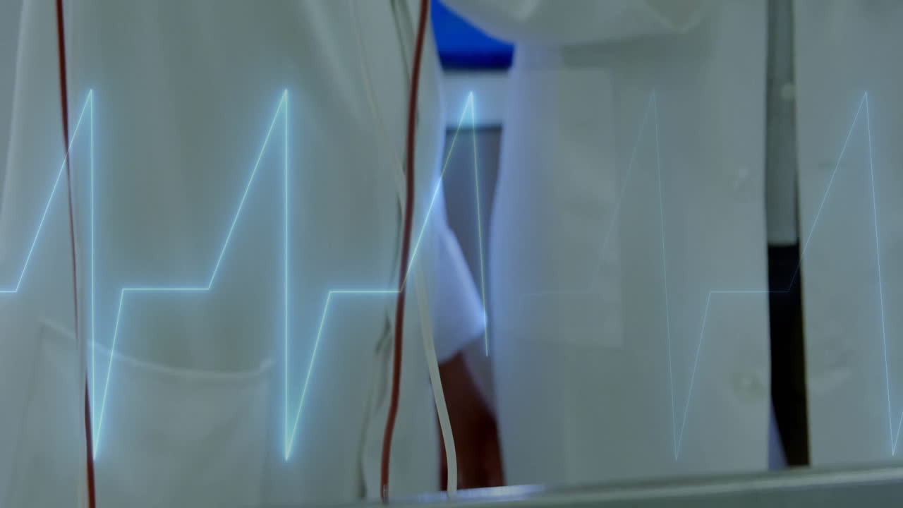 Female doctors monitoring station, displaying glowing ECG waveform over red tubing in health tech
