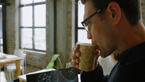 car designers discussing over desktop pc while having coffee 4k