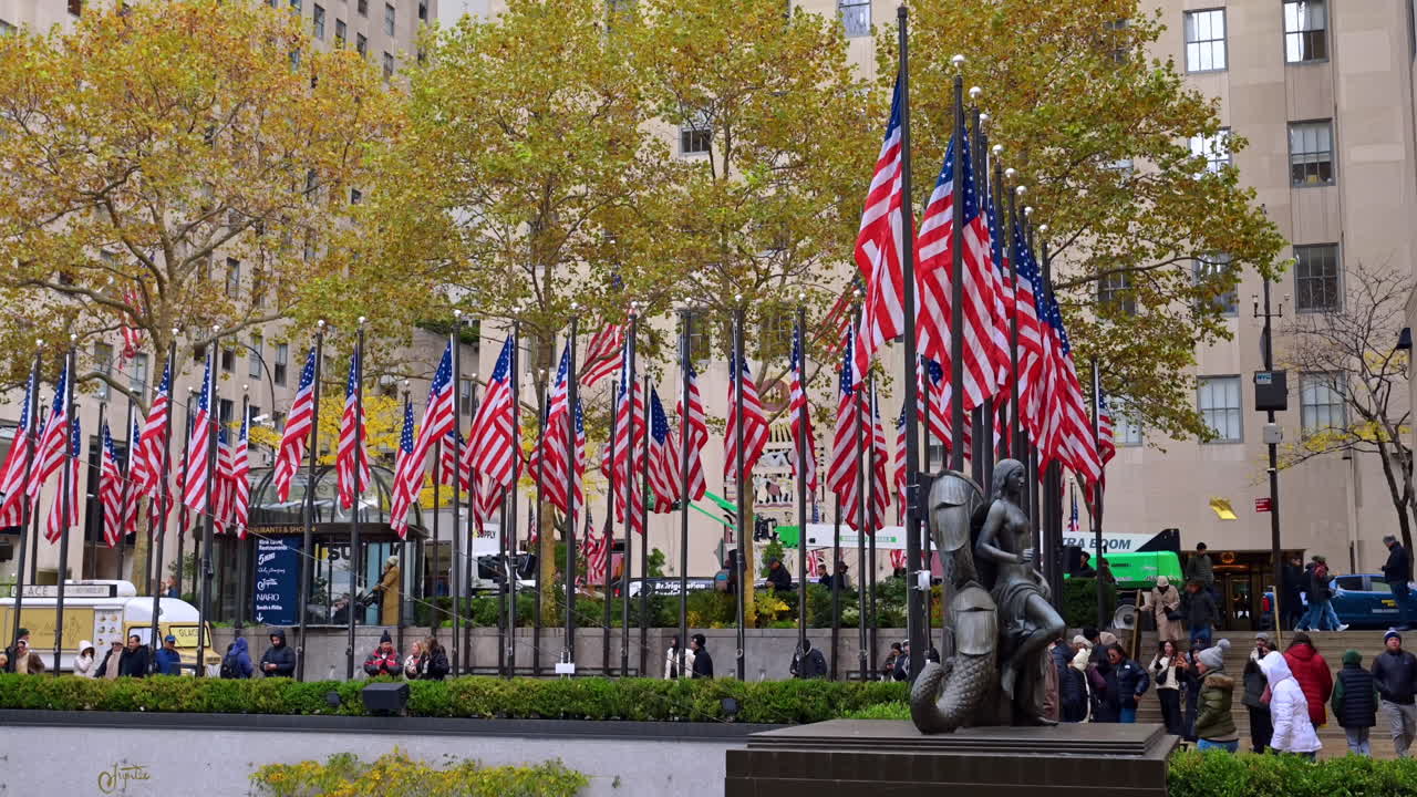 New York, USA, 8 November 2025: Flag display at Rockefeller Plaza. Dozens of American flags decorate the iconic Rockefeller Center plaza