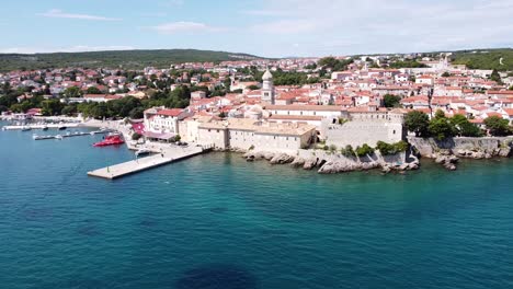 krk village at krk island, croatia - aerial drone view of the cityscape with church, cathedral, city walls, port, boulevard and the adriatic sea