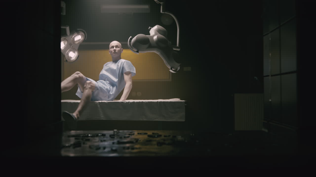 A bald man wakes up in the empty operation room