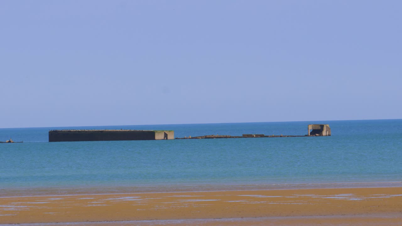 View on Gold Beach WW2 D-Day Landing Site with Historic Artificial Harbour Ruins in Sea in Normandy, France, Europe 4K