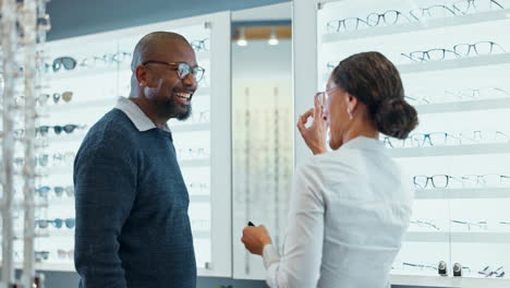 man and woman discussing glasses at an optical store