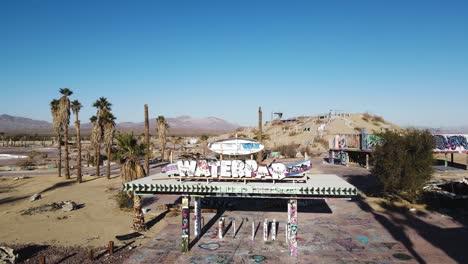 aerial footage of an abandoned waterpark entrance with an overview of the land