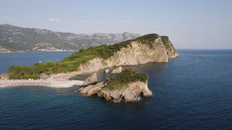 budva's sveti nikola island, montenegro with scenic coastline view - aerial