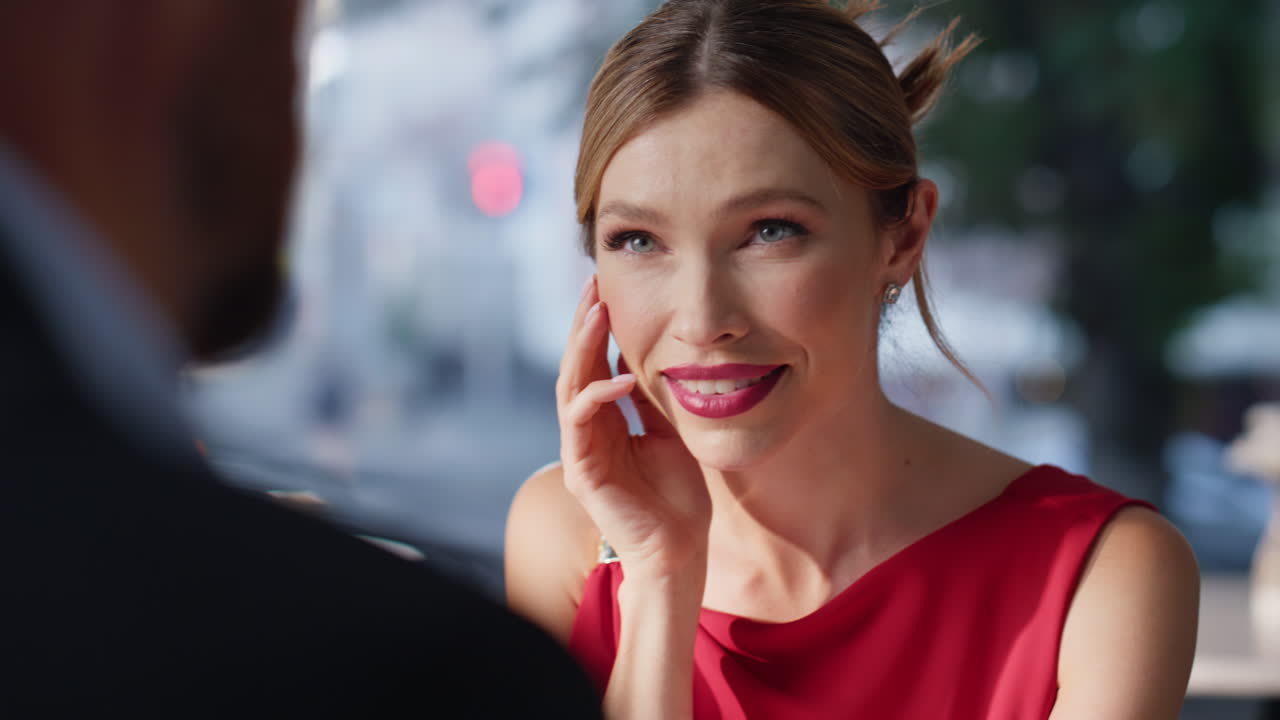 Closeup pair holding hands at restaurant. Happy romantic couple celebrating
