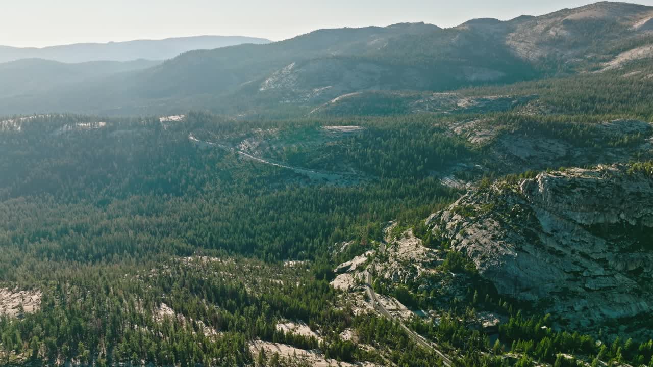 Forest on rocky mountain in Yosemite National Park at autumn sunny day